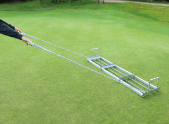Image of Level Lawn Pull Behind Spreader - 72 in. being pulled on green turf
